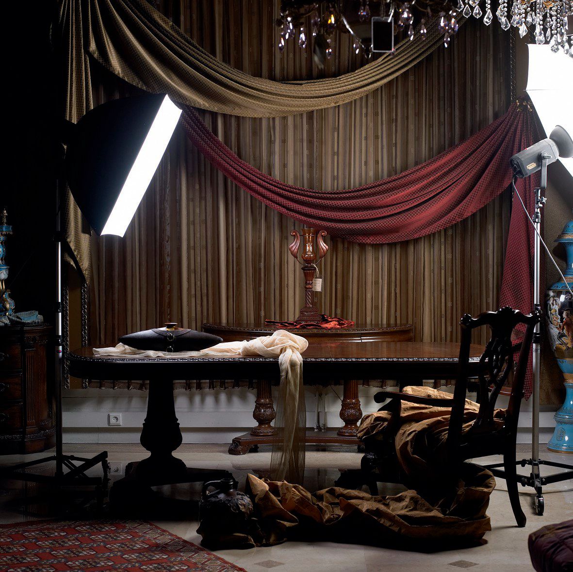 Parang Design studio — draped fabrics, antique table, and dramatic lighting