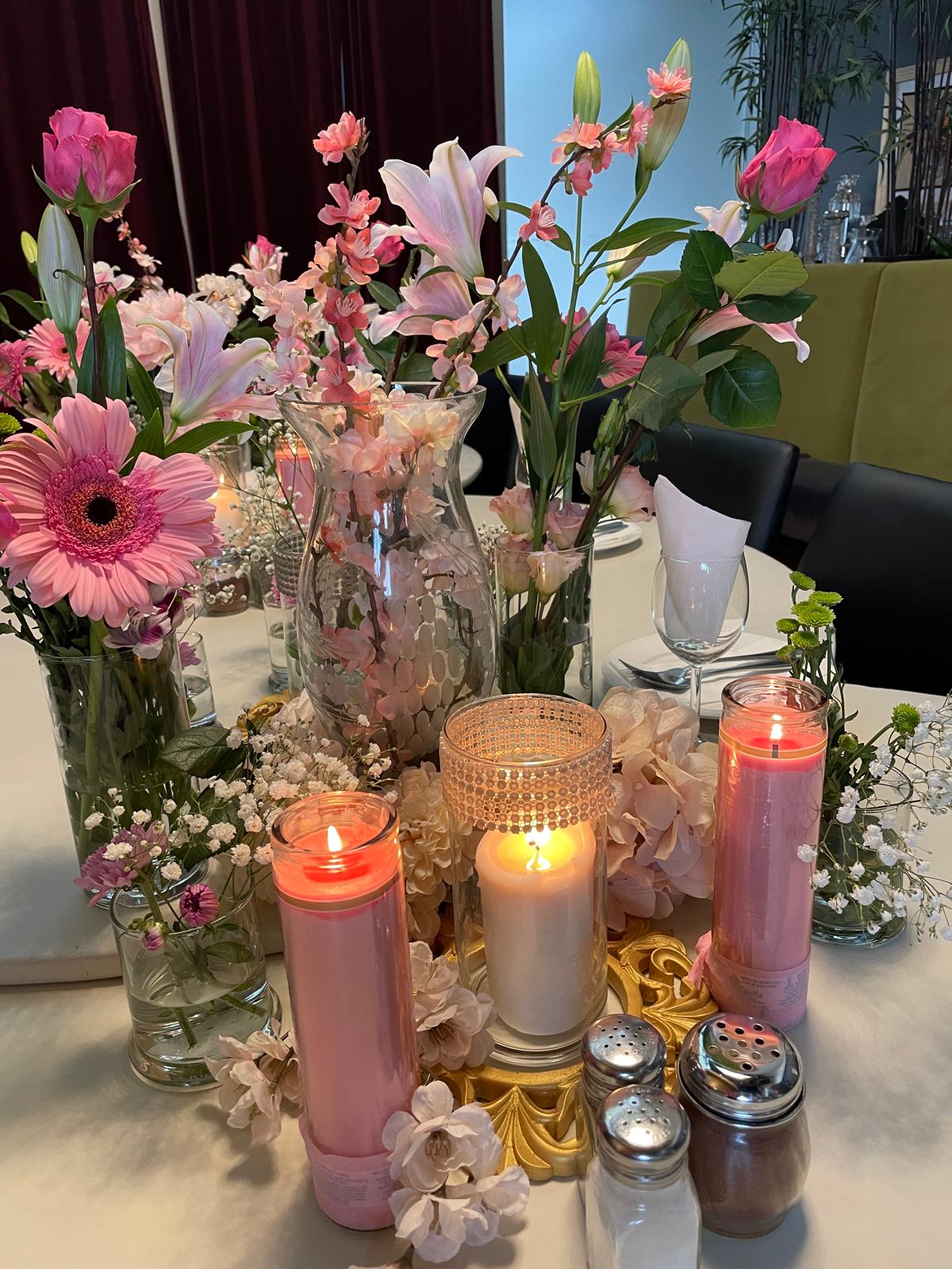 Floral centrepiece — pink lilies & candlelight